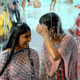 Girls smile as they enjoy a shower in a water park to in the outskirts of Bhopal.